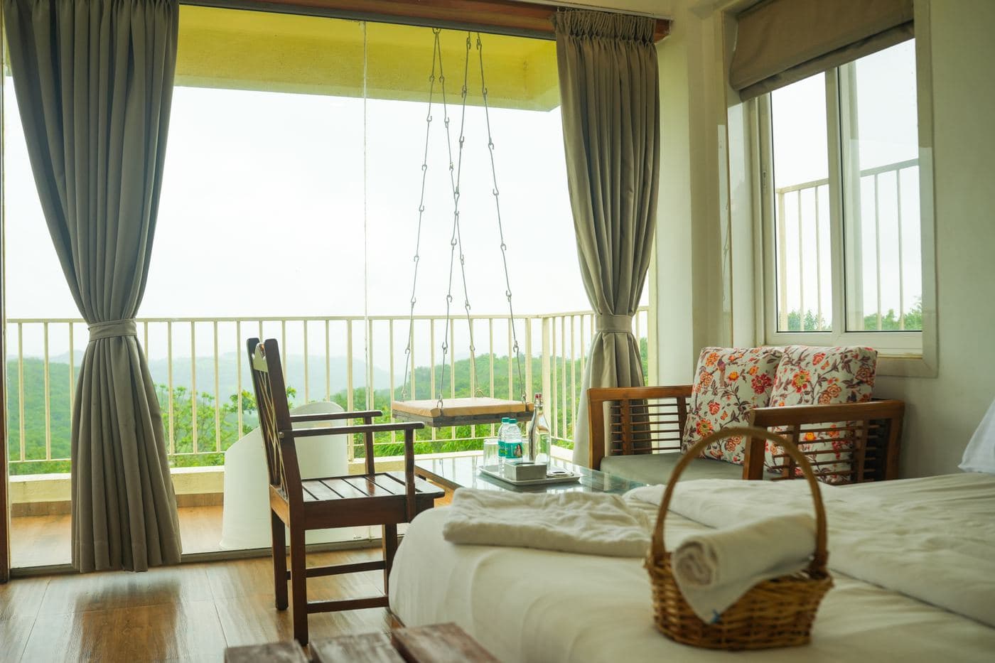 Shivneri Deluxe Room balcony with a swing